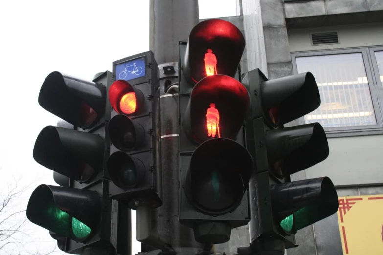 a street light in the city with many red traffic lights