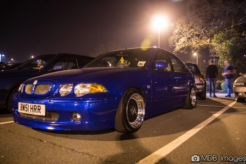 a blue car is parked in a parking lot