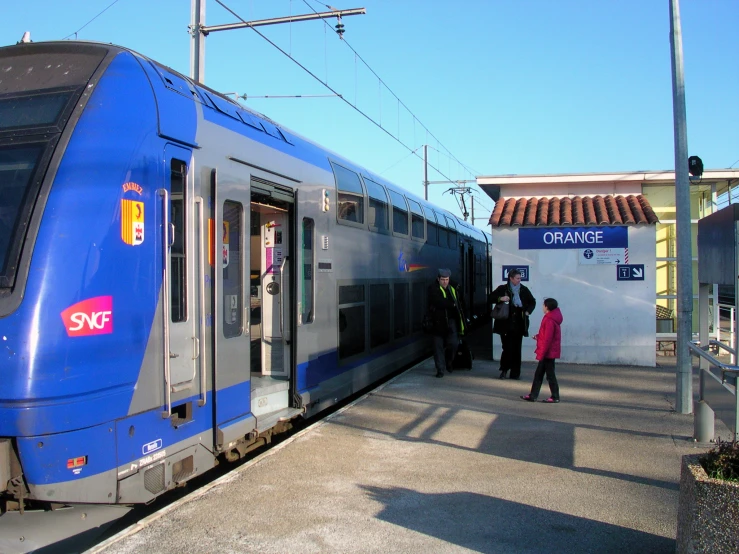 two people getting onto a train from the side