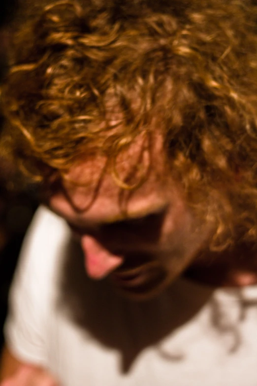 this is an image of a young man with curly hair