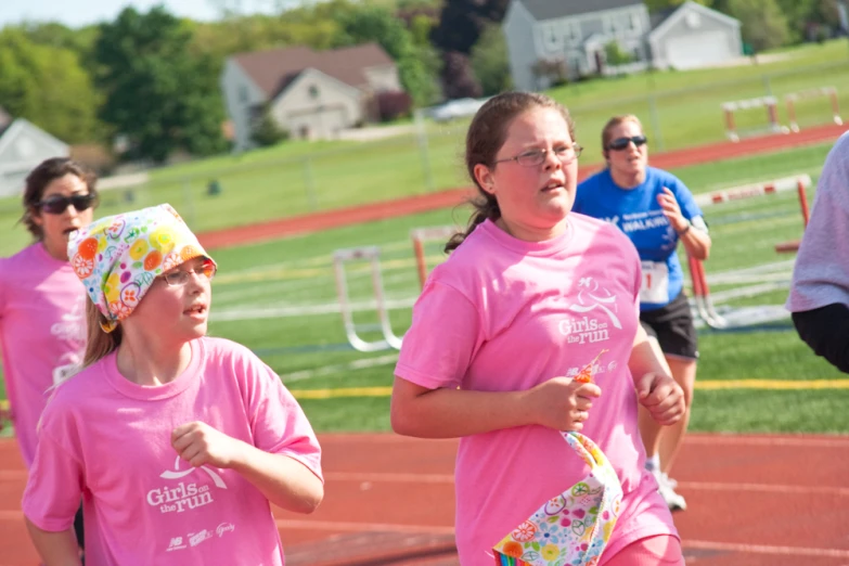 a group of people are wearing pink on the run