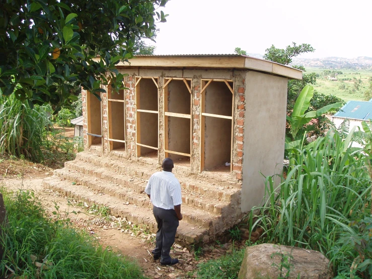 a man standing outside of a building under construction