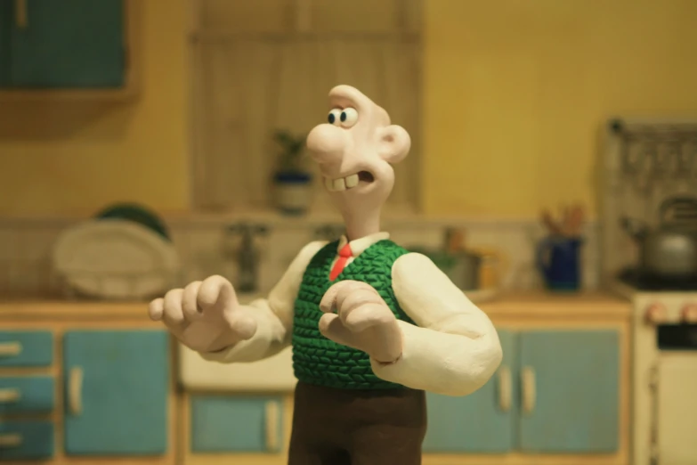 a toy figure wearing a green shirt and brown pants