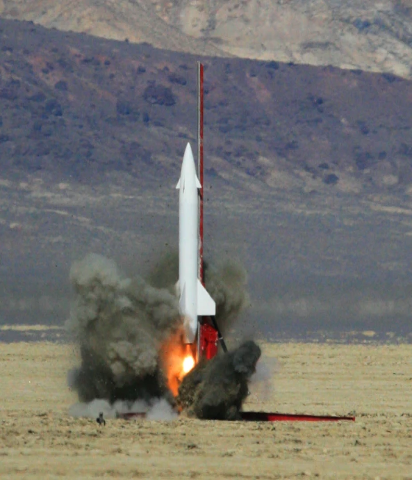 a rocket takes off from the ground with its front end showing a lot of smoke
