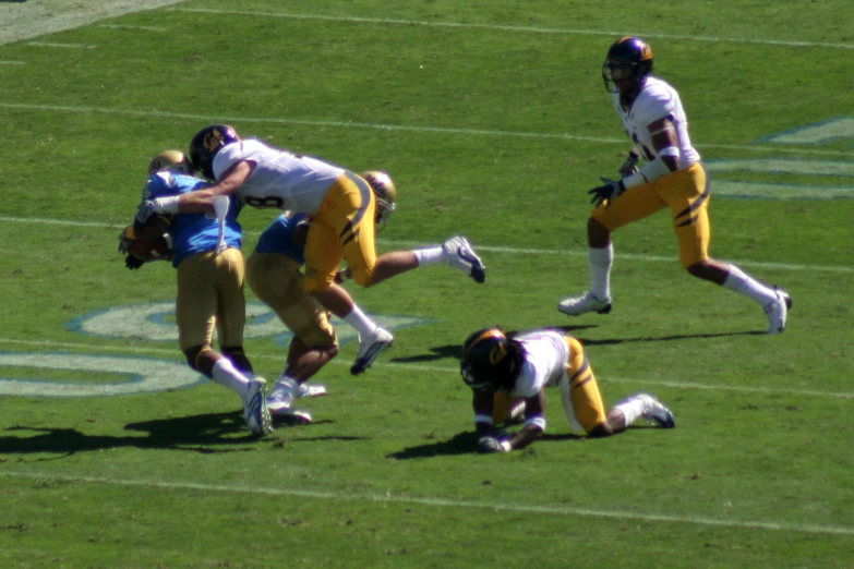 two football players playing football on a field