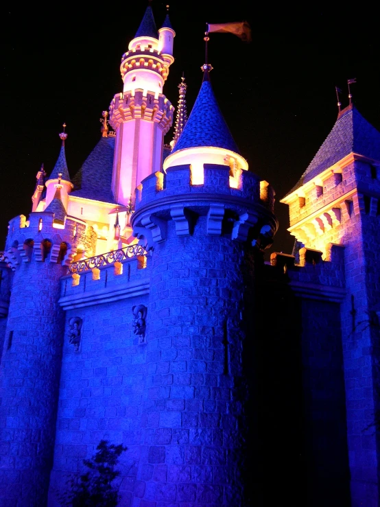 the castle is lit up purple with lights