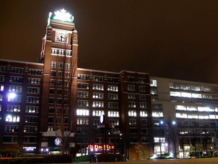 a large clock tower in the center of a night scene