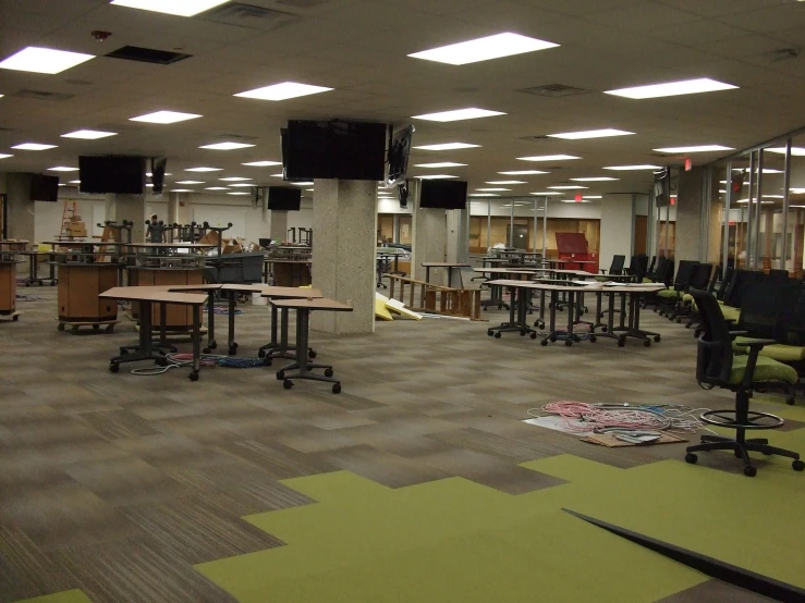 a room filled with lots of desks and chairs