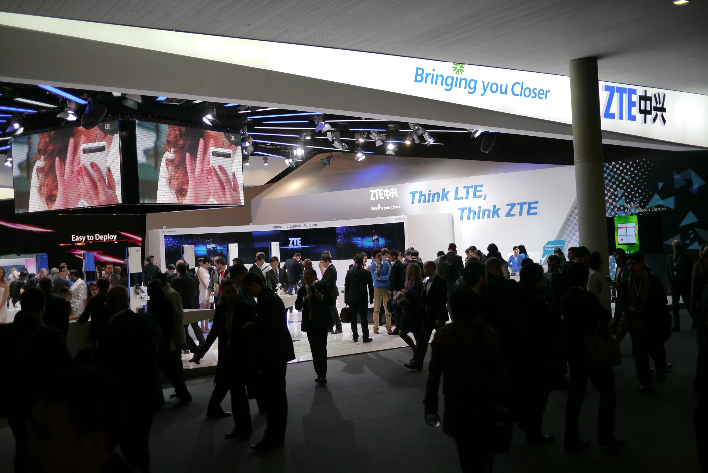 large group of people are walking about at an event