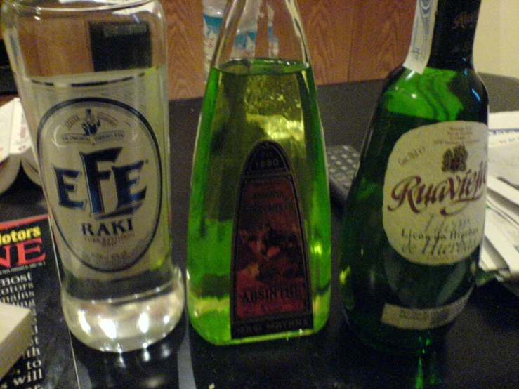 two different bottles of alcohol with one containing a small amount