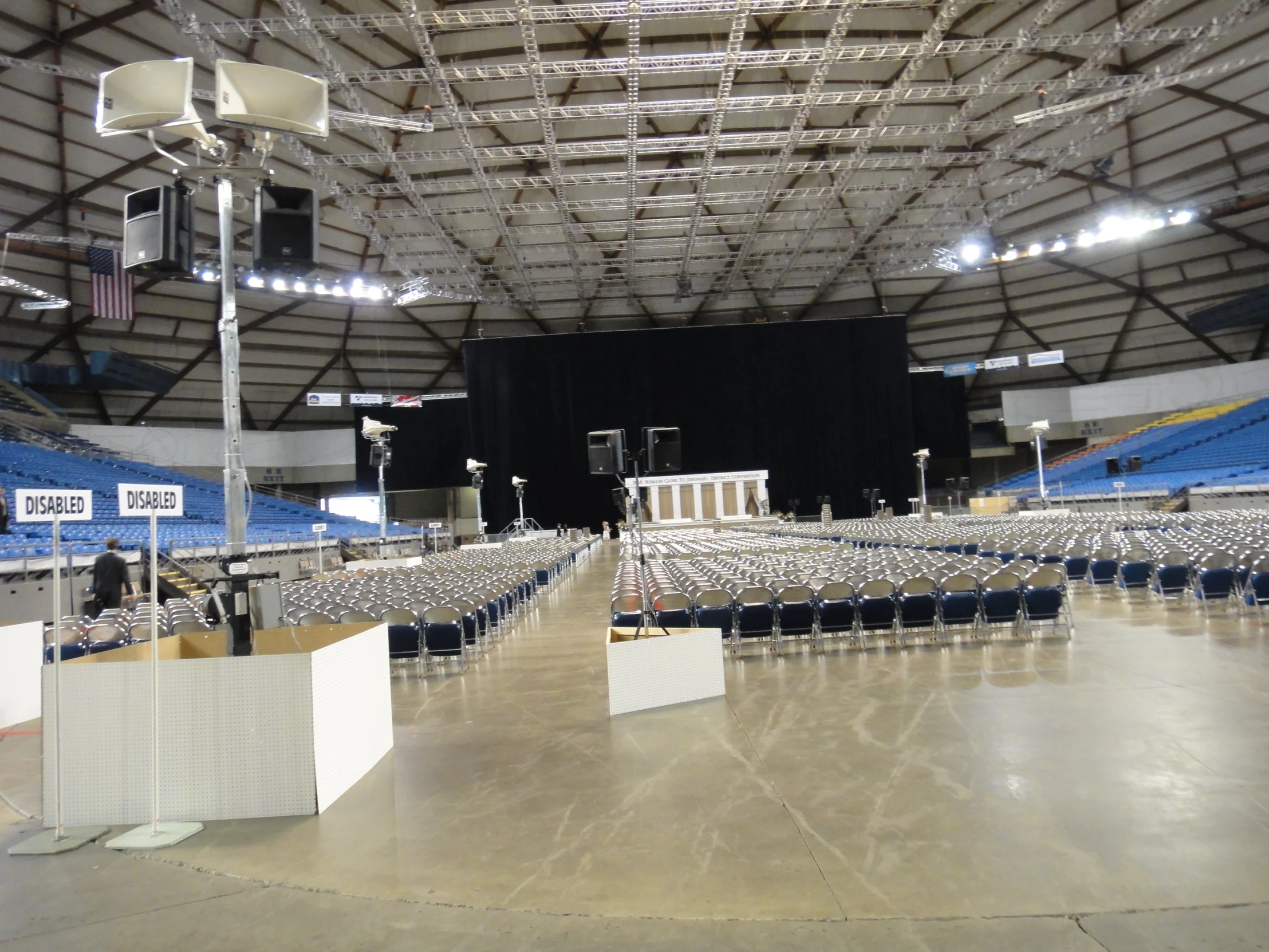 a group of chairs in an auditorium under a roof