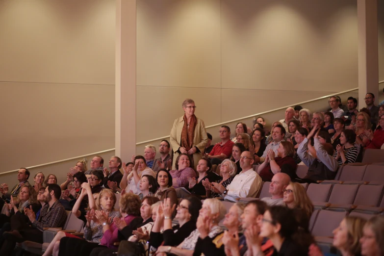 a group of people are sitting in a row