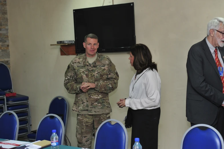 two military officers and a woman in suits