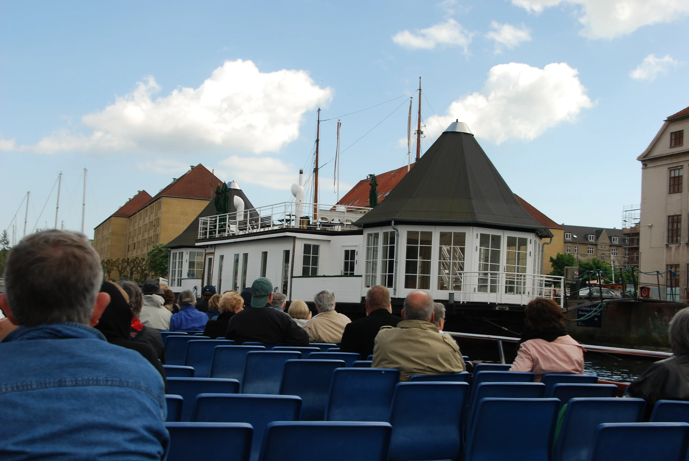 people in a boat on the water watching soing