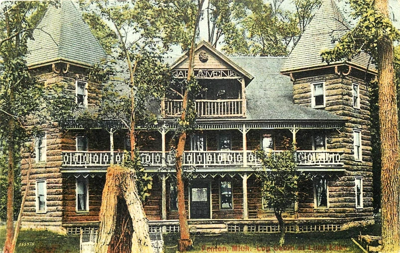 a big wooden house surrounded by trees and bushes