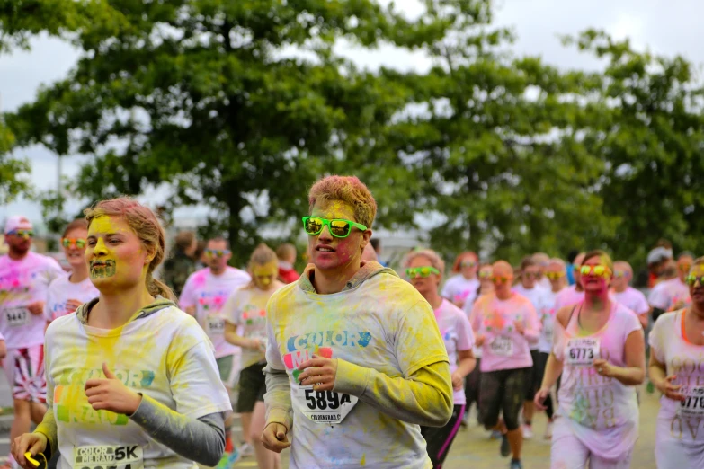 a group of people run a color run together