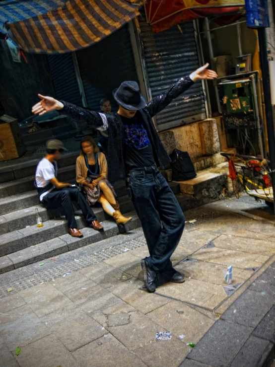 a man is dancing outside on the street