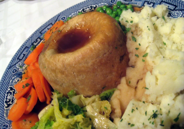 a blue plate topped with food and veggies