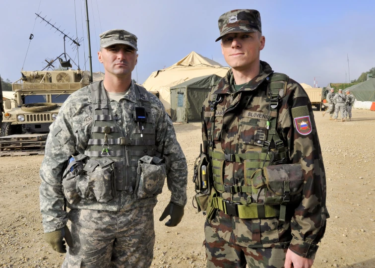 two soldiers stand next to each other in front of a building