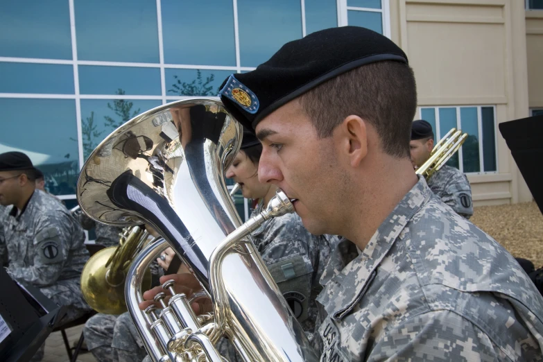 a us military soldier plays the trumpet for an audience