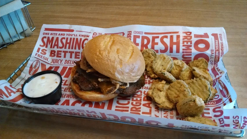 a roast beef sandwich on top of a bun with fries