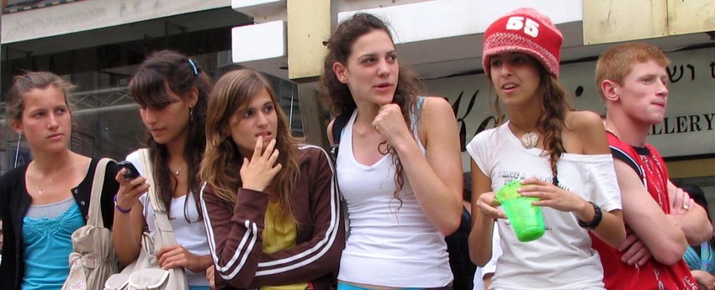 a group of friends standing on the side of the street