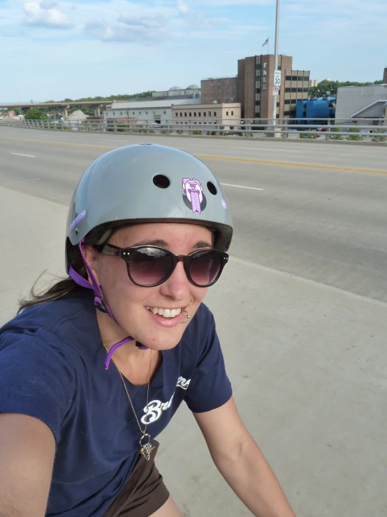 a woman smiles while riding on a motorbike