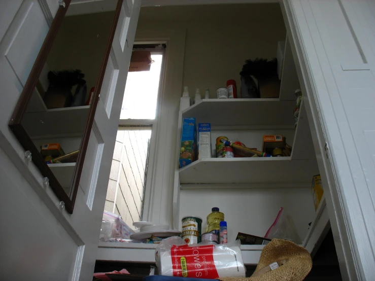 a view of the shelves in the closet, from under the door