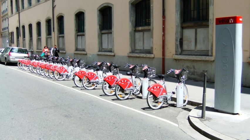 rows of bicycles are lined up on the sidewalk