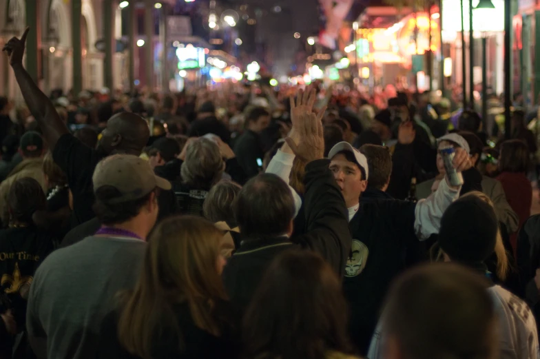 people standing around each other in front of a crowd