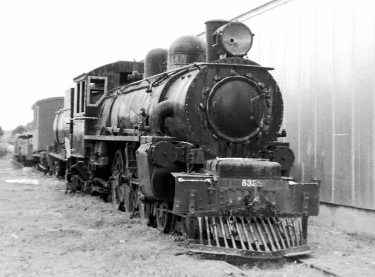 this is an old locomotive in front of a building