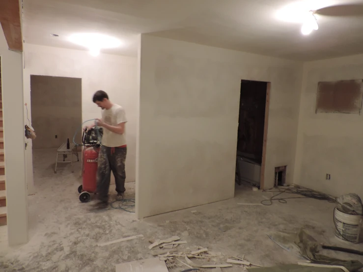 man working on a painting in a new home