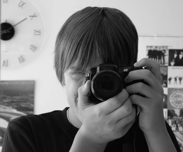 a boy takes a po with his camera