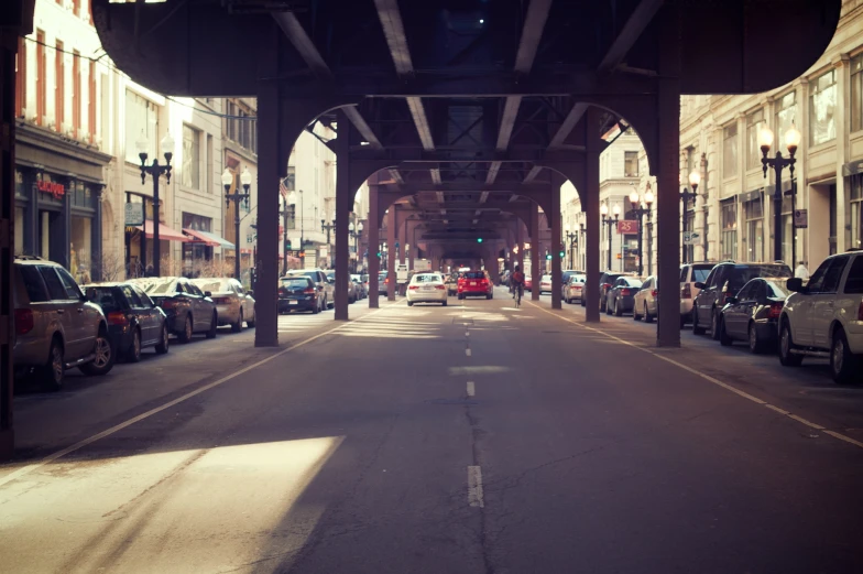 cars line up at an intersection near the bridge