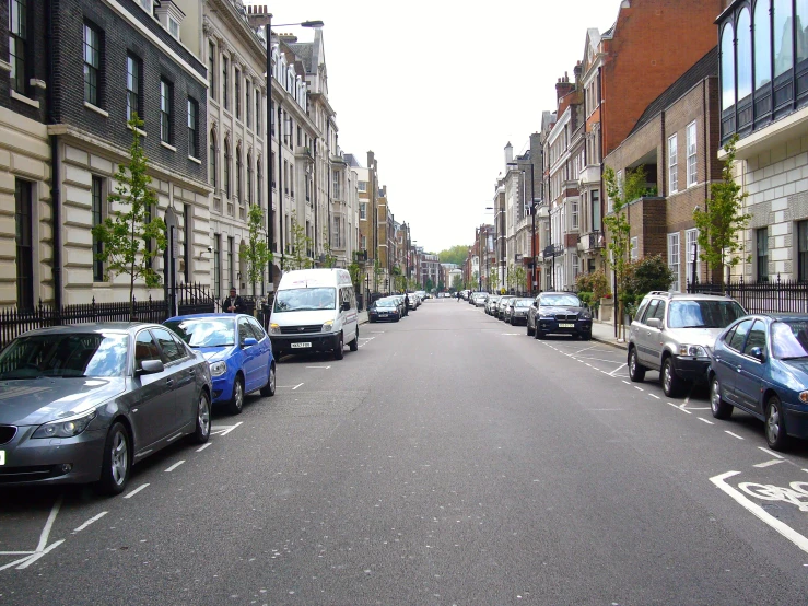 a street lined with cars parked on the side of it