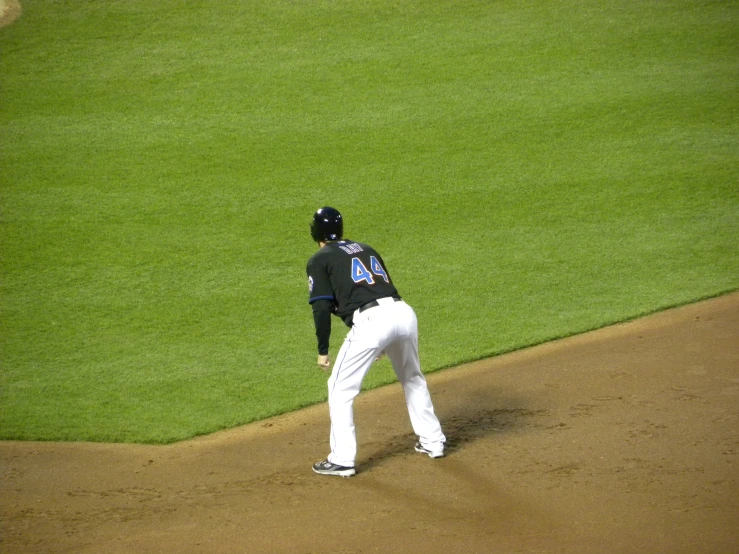 baseball player standing at home plate ready to make a play