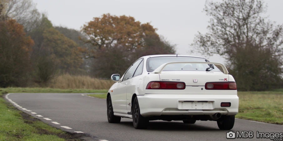 a white car traveling down the road