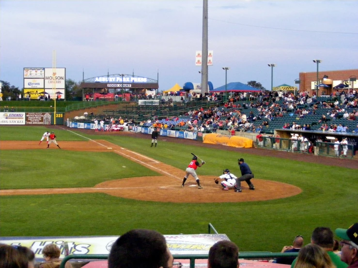 an overview of a baseball game where the batter stands ready to swing at the ball
