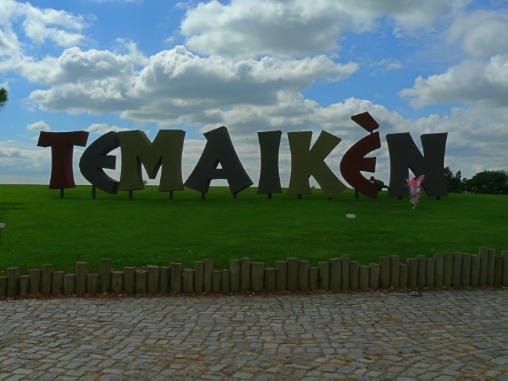 the name temakgen spelled in the middle of a green park