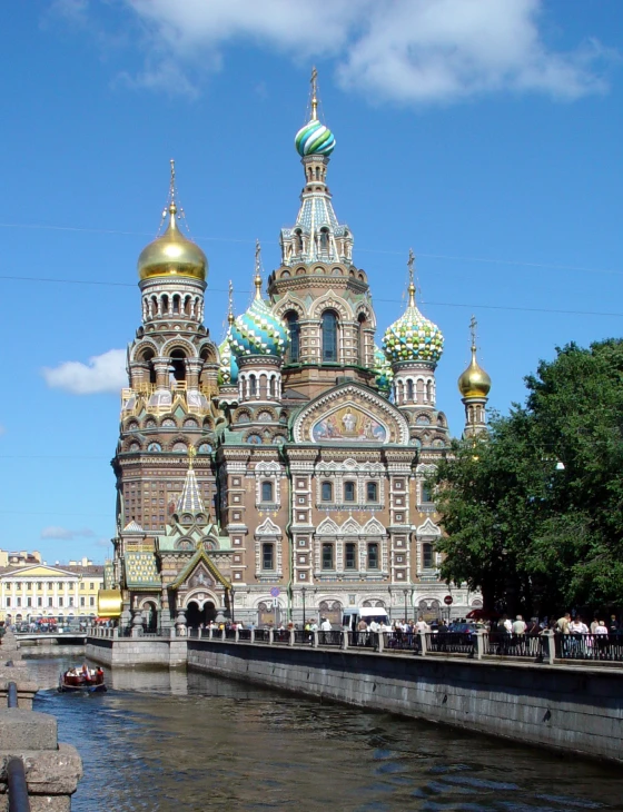 a picture taken from a boat looking at a church with gold and blue dome