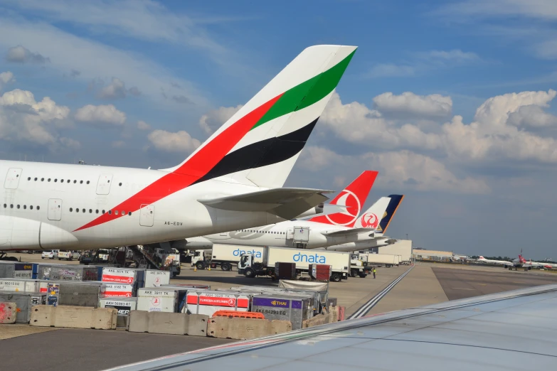 large airplanes sitting on top of an airport runway