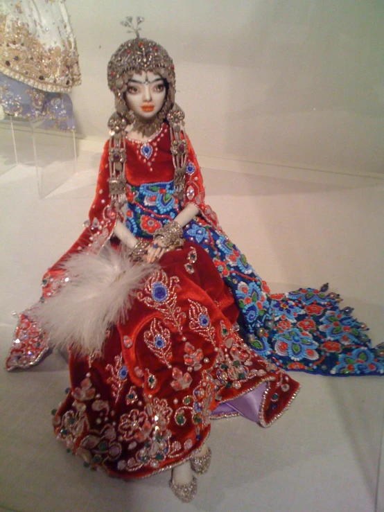 a woman in an elaborate dress on a display