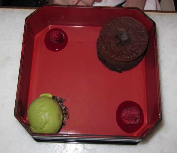 some very cute small desserts in a big red tray