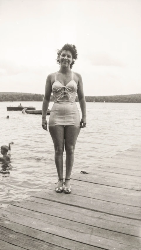 a woman in a bathing suit on a pier