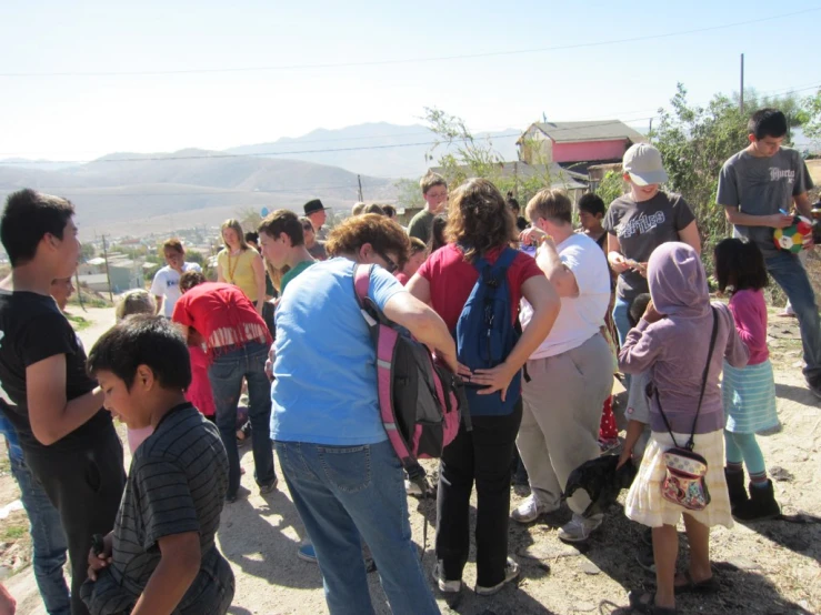 a large group of people huddled in a village