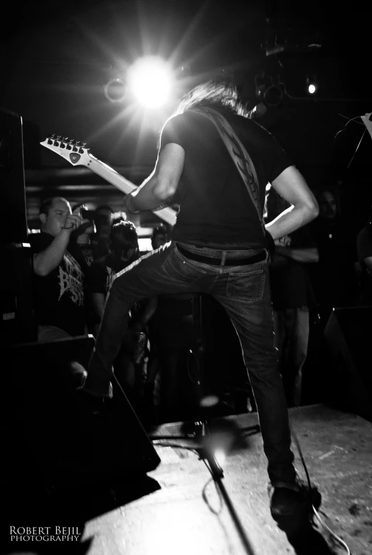 a guy that is playing a guitar on a stage