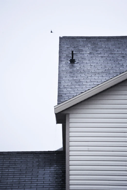 a roof and a window on a home with the door open