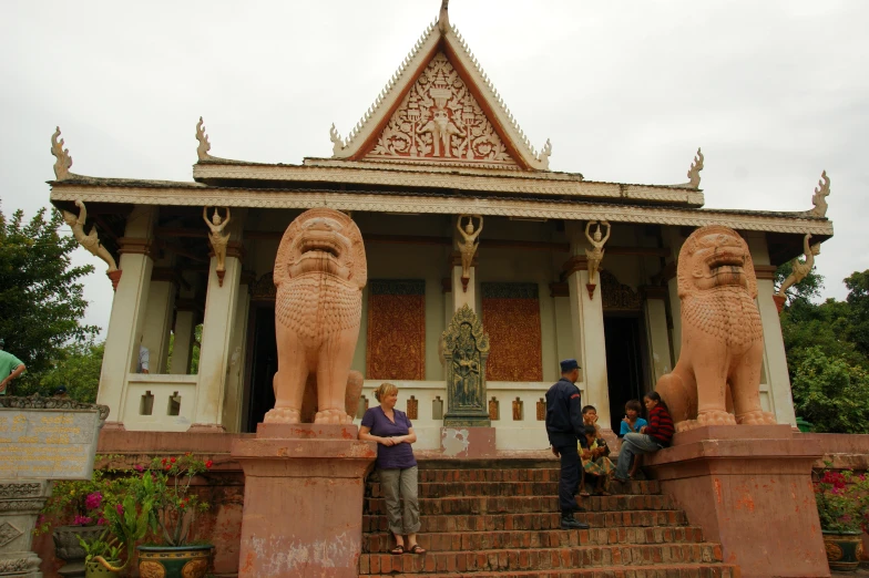 an ornate structure in the middle of the park with lions on it