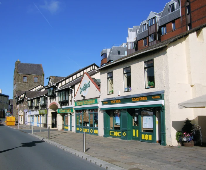 street scene with the storefronts on the right and the road and sidewalk