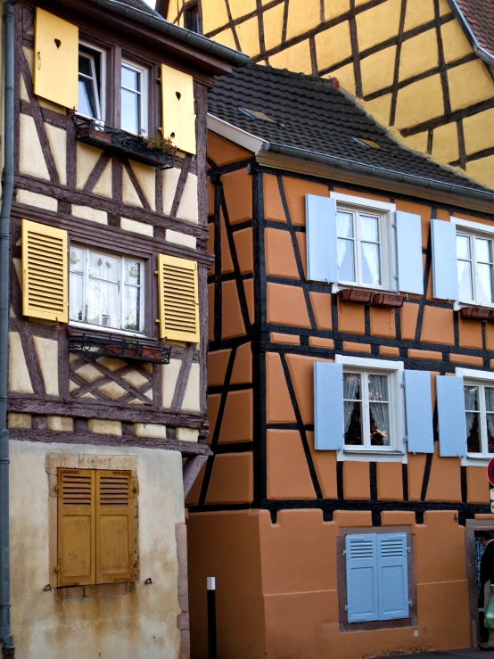 a half - timbered building with two story walls is next to a street